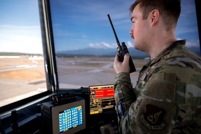 Airman 1st Class David Coleman, 3rd Operations Support Squadron air traffic control specialist, communicates with ground personnel from the air traffic control tower at Joint Base Elmendorf-Richardson, Alaska, August 5, 2025.