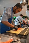 SEATTLE (Aug. 1, 2025) – U.S. Navy Culinary Specialist Seaman Quintin Dorsey, from New Orleans, prepares a fish at Aerlume Seattle during Seattle Fleet Week, Aug. 1, 2025. Seattle Fleet Week is a time-honored celebration of the sea services and provides an opportunity for the citizens of Washington to meet Sailors, Marines and Coast Guardsmen, as well as witness firsthand the latest capabilities of today’s maritime services. (U.S. Navy Photo by Mass Communication Specialist 2nd Class John A. Miller)