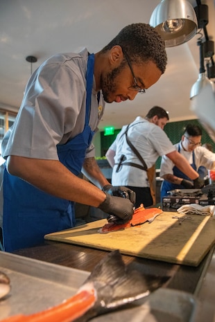 SEATTLE (Aug. 1, 2025) – U.S. Navy Culinary Specialist Seaman Quintin Dorsey, from New Orleans, prepares a fish at Aerlume Seattle during Seattle Fleet Week, Aug. 1, 2025. Seattle Fleet Week is a time-honored celebration of the sea services and provides an opportunity for the citizens of Washington to meet Sailors, Marines and Coast Guardsmen, as well as witness firsthand the latest capabilities of today’s maritime services. (U.S. Navy Photo by Mass Communication Specialist 2nd Class John A. Miller)