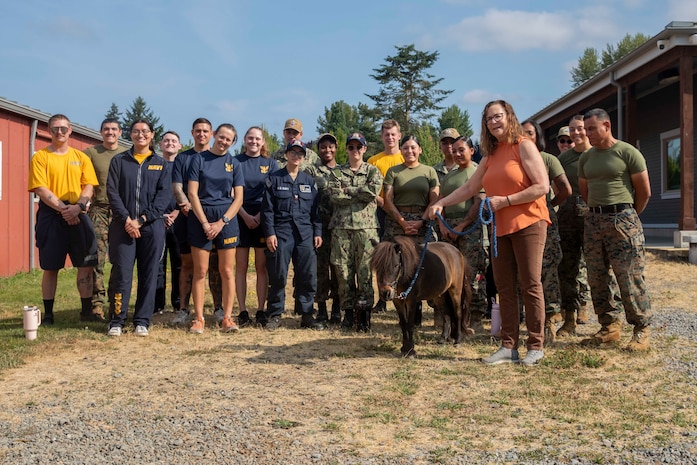 Sailors and Marines pose for a picture with a miniature horse at the Little Bit Therapeutic Riding Center during Seattle Fleet Week 2025. Seattle Fleet Week is a time-honored celebration of the sea services and provides an opportunity for the citizens of Washington to meet Sailors, Marines and Coast Guardsmen, as well as witness firsthand the latest capabilities. of today’s maritime services. (U.S. Navy photo by Mass Communication Specialist Seaman Joey Sitter)