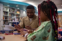Lance Cpl. Austin Miller, from Southaven, Miss., assigned to amphibious transport dock ship USS Somerset (LPD 25), plays a card game with a patient at the Seattle Children’s Hospital during Seattle Fleet Week 2025. Seattle Fleet Week is a time-honored celebration of the sea services and provides an opportunity for the citizens of Washington to meet Sailors, Marines and Coast Guardsmen, as well as witness firsthand the latest capabilities. of today’s maritime services. (U.S. Navy photo by Mass Communication Specialist Seaman Joey Sitter)