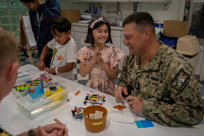 Boatswain’s Mate 1st Class Nathan Burnau, from Barstow, Calif., assigned to the Arleigh Burke-class guided missile destroyer USS Jack H. Lucas (DDG 125), does arts and crafts with patients at the Seattle Children’s Hospital during Seattle Fleet Week 2025. Seattle Fleet Week is a time-honored celebration of the sea services and provides an opportunity for the citizens of Washington to meet Sailors, Marines and Coast Guardsmen, as well as witness firsthand the latest capabilities. of today’s maritime services. (U.S. Navy photo by Mass Communication Specialist Seaman Joey Sitter)