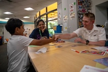 Ensign Mitchell Duncan, from Cleveland, assigned to the Arleigh Burke-class guided missile destroyer USS Jack H. Lucas (DDG 125), congratulates a patient at the Seattle Children’s Hospital on winning a game of Uno during Seattle Fleet Week 2025. Seattle Fleet Week is a time-honored celebration of the sea services and provides an opportunity for the citizens of Washington to meet Sailors, Marines and Coast Guardsmen, as well as witness firsthand the latest capabilities. of today’s maritime services. (U.S. Navy photo by Mass Communication Specialist Seaman Joey Sitter)