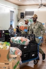 Hospital Corpsman 3rd Class Richard Gyan Jr., right, and Yeoman Seaman Donciel Lembi, both assigned to amphibious transport dock ship USS Somerset (LPD 25), transport food during a food bank at Providence Regina House as part of Seattle Fleet Week, Aug. 2, 2025. Seattle Fleet Week is a time-honored celebration of the sea services and provides an opportunity for the citizens of Washington to meet Sailors, Marines and Coast Guardsmen, as well as witness firsthand the latest capabilities of today’s maritime services. (U.S. Navy photo by Mass Communication Specialist 2nd Class Evan Diaz)
