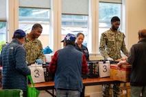 Sailors assigned to amphibious transport dock ship USS Somerset (LPD 25) serve guests during a food bank at Providence Regina House as part of Seattle Fleet Week, Aug. 2, 2025. Seattle Fleet Week is a time-honored celebration of the sea services and provides an opportunity for the citizens of Washington to meet Sailors, Marines and Coast Guardsmen, as well as witness firsthand the latest capabilities of today’s maritime services. (U.S. Navy photo by Mass Communication Specialist 2nd Class Evan Diaz)