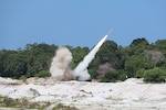A High Mobility Artillery Rocket System operated by members of the Oklahoma Army National Guard's 1st Battalion, 158th Field Artillery Regiment fires a rocket during Exercise Keris Strike, on July 30, 2025.