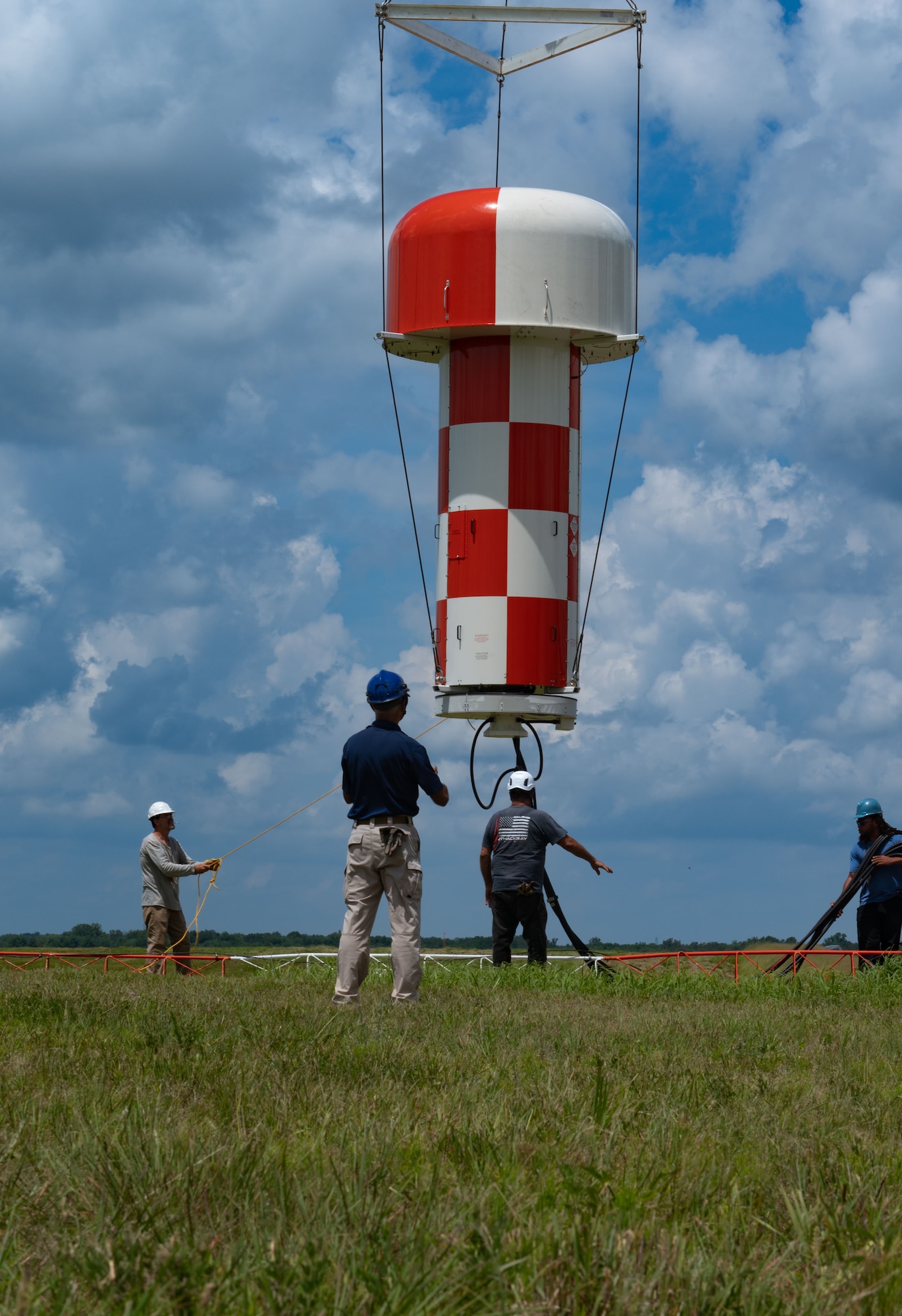 Contractors guide the newly installed AN/FPN-68 Precision Approach Radar system to its designated spot at Joint Base McGuire-Dix-Lakehurst, N.J., July 16, 2025. The PAR system is used by U.S. Marine’s assigned to Marine Aircraft Group 49 for the Bell UH-1Y and Bell AH-1Z and is maintained by the 305th Operations Support Squadron Radar, Airfield and Weather Systems technicians. (U.S. Air Force photo by Airman Haeleigh Bayle)
