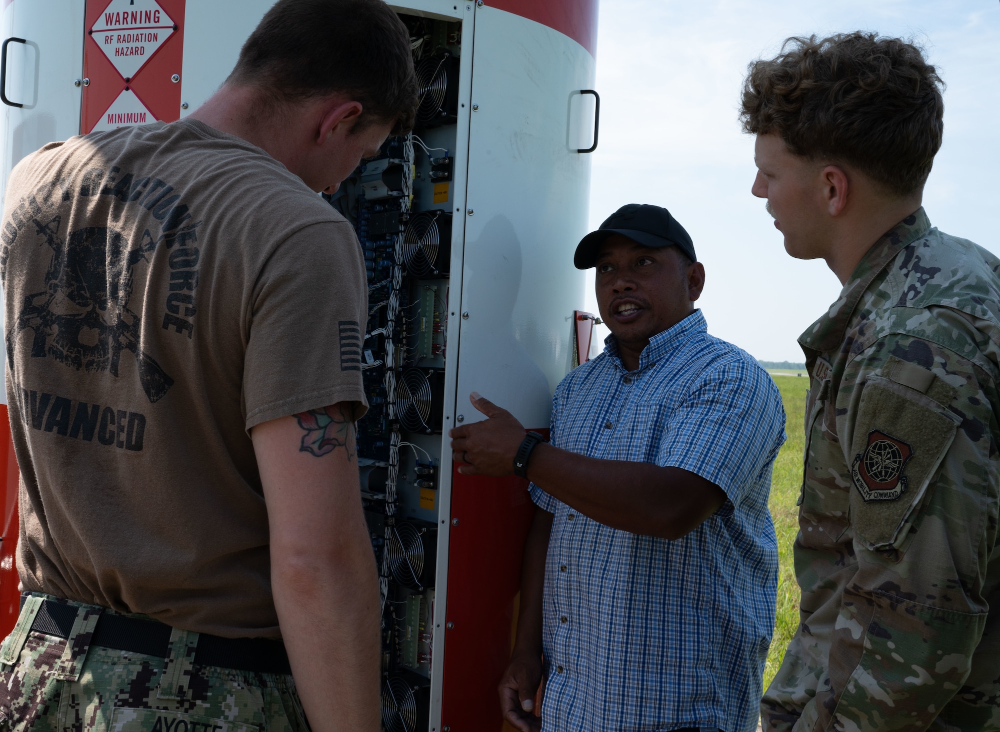 Joemar Abad, Information Warfare Center Precision Approach Radar In-Service Engineering Agent, explains the PAR technological system and proficiency to 305th Operations Support Squadron Radar, Airfield and Weather System technicians at Joint Base McGuire-Dix-Lakehurst, N.J. July 29, 2025. Abad held briefings and informed service members of the PAR capabilities to equip them with information needed to maintain and repair the system. (U.S. Air Force photo by Airman Haeleigh Bayle)