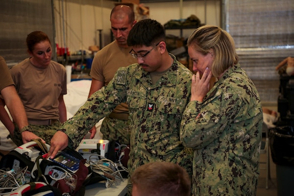 250730-N-KC192-2021 FORT RUCKER, Ala. (July 30, 2025) Hospital Corpsman 2nd Class Pedro Garcia, assigned to the Navy’s Enroute Care System Reserve Team, and Lt.Cmdr Mary-Catherine Taylor, assigned to Expeditionary Resuscitative Surgical System 3 participate in equipment familiarization with ventilation equipment during the Joint Enroute Care Course (JECC) on Fort Rucker, Alabama, July 30, 2025. The purpose of JECC training is to operationalize clinical skills of servicemembers and introduce them to a standardized methodology for providing critical care while transporting a patient through the battle space during deployment as members of teams operating in austere environments. (U.S. Navy photo by Mass Communication Specialist 2nd Class Levi Decker)