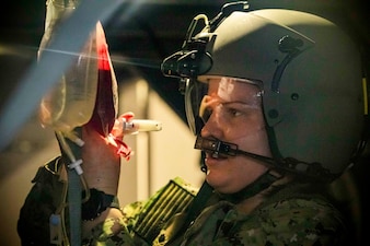 250731-N-KC192-1112 FORT RUCKER, Ala. (July 31, 2025) Hospital Corpsman 2nd Class Kelly Jurkouich, assigned to Expeditionary Medical Facility (EMF) Mike 150, treats a simulated casualty during a point of injury simulation as part of the Joint Enroute Care Course (JECCon Fort Rucker, Alabama, July 31, 2025. The purpose of JECC training is to operationalize clinical skills of servicemembers and introduce them to a standardized methodology for providing critical care while transporting a patient through the battle space during deployment as members of teams operating in austere environments. The course enhances joint interoperability by bringing together personnel from across the services to operationalize clinical skills and strengthen integrated medical response during deployment. (U.S. Navy photo by Mass Communication Specialist 2nd Class Levi Decker)