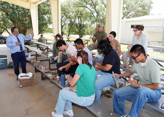 JOINT BASE SAN ANTONIO-FORT SAM HOUSTON – (July 23, 2025) – Student interns assigned to Naval Medical Research Unit (NAMRU) San Antonio enrolled in the Office of Naval Research’s Naval Research Enterprise Internship Program (NREIP) and Oak Ridge Institute for Science and Education (ORISE) had the opportunity to eat Meals, Ready-to-Eat for lunch during their trip to the Camp Bullis. Prior to lunch, the interns observed Air Force Expeditionary Medical Service (EMEDS) training at the camp. Navy Medicine Research & Development (NMR&D) makes use of multiple channels to recruit and retain critical U.S. Navy medical support personnel. The research commands reach out to the next generation of scientists through conferences, STEM events, internships and career days, and support recruiting efforts early in undergraduate and graduate programs. NAMRU San Antonio, part of NMR&D, conducts gap-driven combat casualty care, craniofacial, and directed energy research in support of Navy, Marine Corps and joint U.S. warfighter health readiness and lethality while engaged in routine and expeditionary operations. (U.S. Navy photo by Burrell Parmer, NAMRU San Antonio Public Affairs/Released)