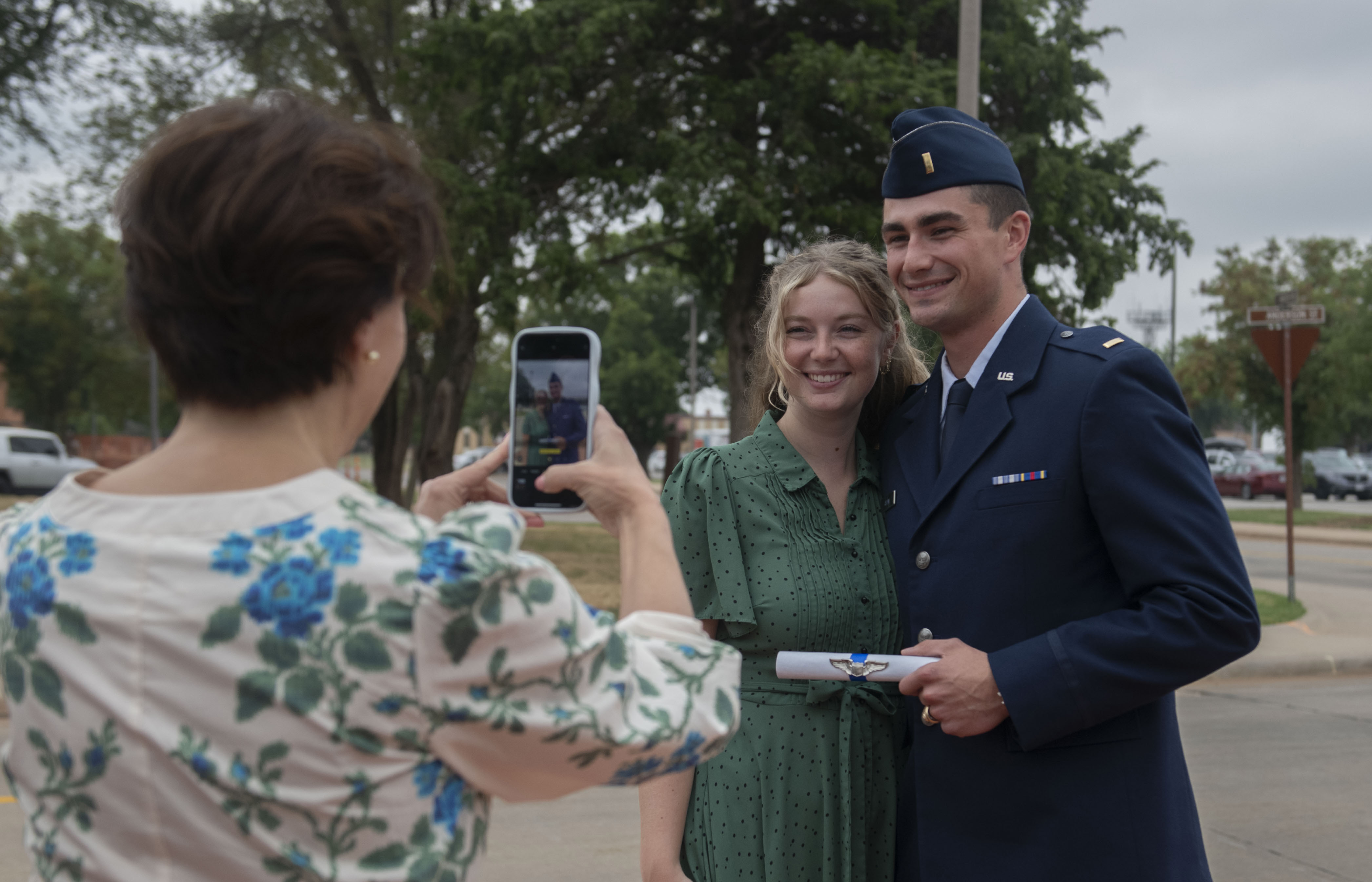 Student pilots in Class 25-13 pin on their wings during graduation