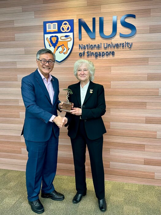 Naval Postgraduate School president retired U.S. Navy Vice Adm. Ann E. Rondeau, Ed.D. presents a Monterey Cypress tree to National University of Singapore President professor Tan Eng Chye as measure of appreciation celebrating the new joint degree program between the two institutions, July 23.