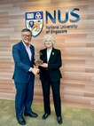 Naval Postgraduate School president retired U.S. Navy Vice Adm. Ann E. Rondeau, Ed.D. presents a Monterey Cypress tree to National University of Singapore President professor Tan Eng Chye as measure of appreciation celebrating the new joint degree program between the two institutions, July 23.