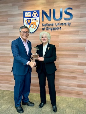 Naval Postgraduate School president retired U.S. Navy Vice Adm. Ann E. Rondeau, Ed.D. presents a Monterey Cypress tree to National University of Singapore President professor Tan Eng Chye as measure of appreciation celebrating the new joint degree program between the two institutions, July 23.