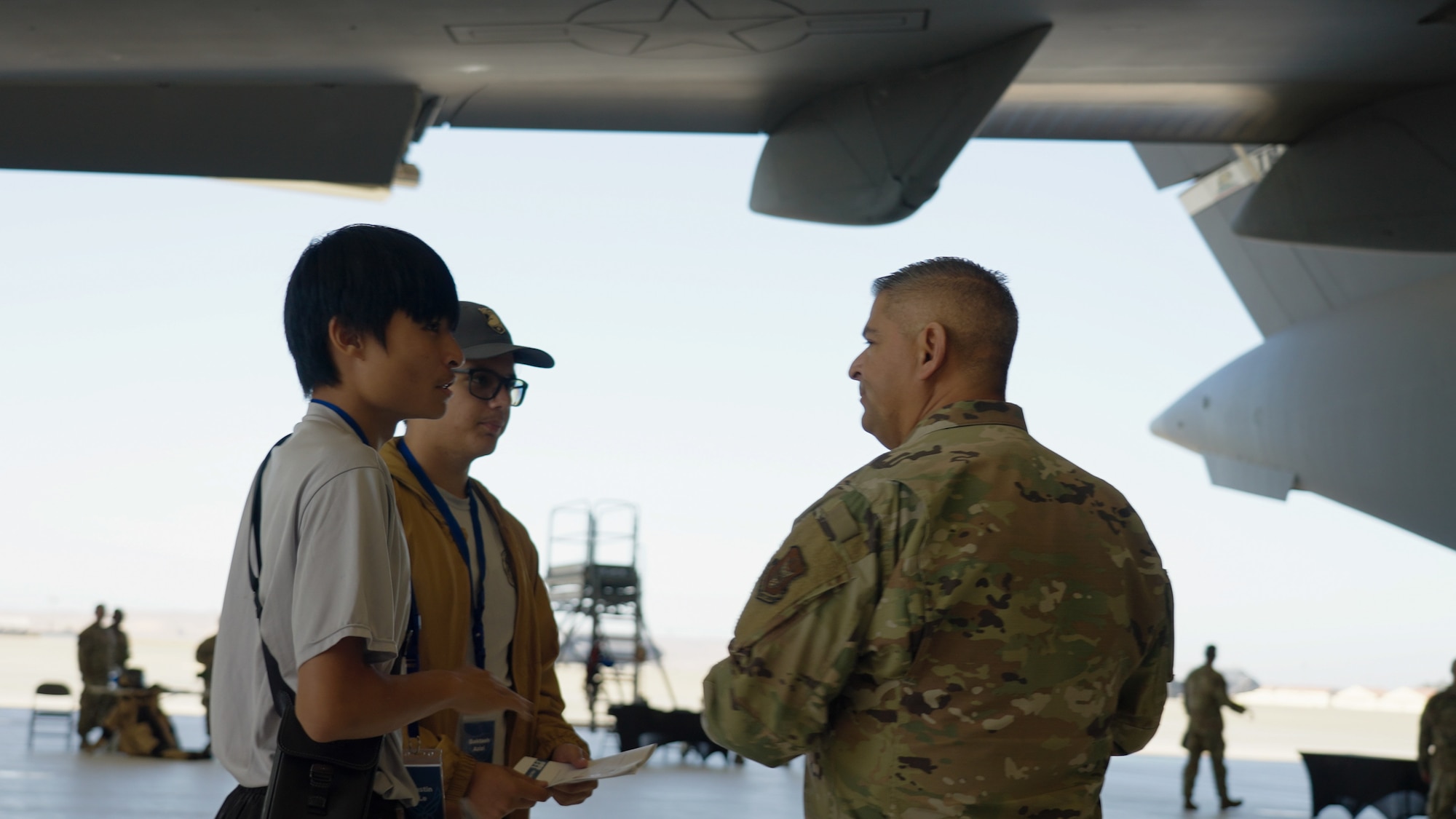 Chief Master Sgt. Raymond R. Betts, 349th Maintenance Group superintendent, speaks with attendees next to a C-17 Globemaster III during the Travis Air Reserve Experience 2025 at Travis Air Force Base, Calif., Aug. 3, 2025. The Travis Air Reserve Experience is a recruiting event designed to give community members an opportunity to interact directly with Reserve Airmen, learn about career paths, and explore the mission of the 349th Air Mobility Wing.