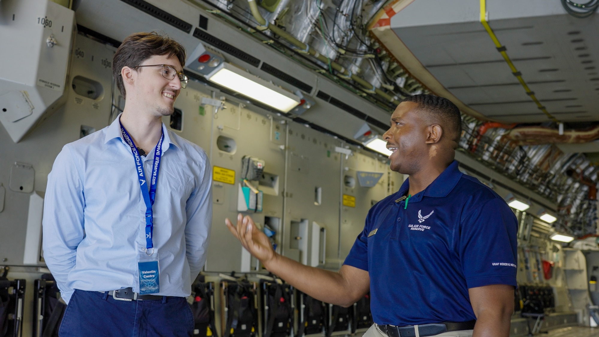 Tech. Sgt. Tre’ Reed, an Air Force recruiter, right, speaks with Valentin Castro, a college junior studying mechanical engineering, about career opportunities during the Travis Air Reserve Experience 2025 at Travis Air Force Base, Calif., Aug. 3, 2025. The Travis Air Reserve Experience is a recruiting event designed to give community members an opportunity to interact directly with Reserve Airmen, learn about career paths, and explore the mission of the 349th Air Mobility Wing.