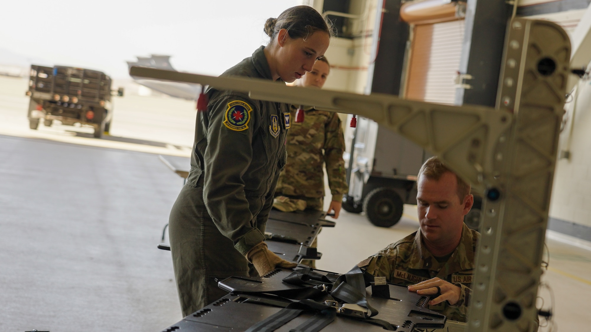 Reserve Airmen assigned to the 349th Aeromedical Evacuation Squadron demonstrate patient litter loading procedures using a mannequin for attendees during the Travis Air Reserve Experience 2025 at Travis Air Force Base, Calif., Aug. 3, 2025. The Travis Air Reserve Experience is a recruiting event designed to give community members an opportunity to interact directly with Reserve Airmen, learn about career paths, and explore the mission of the 349th Air Mobility Wing.