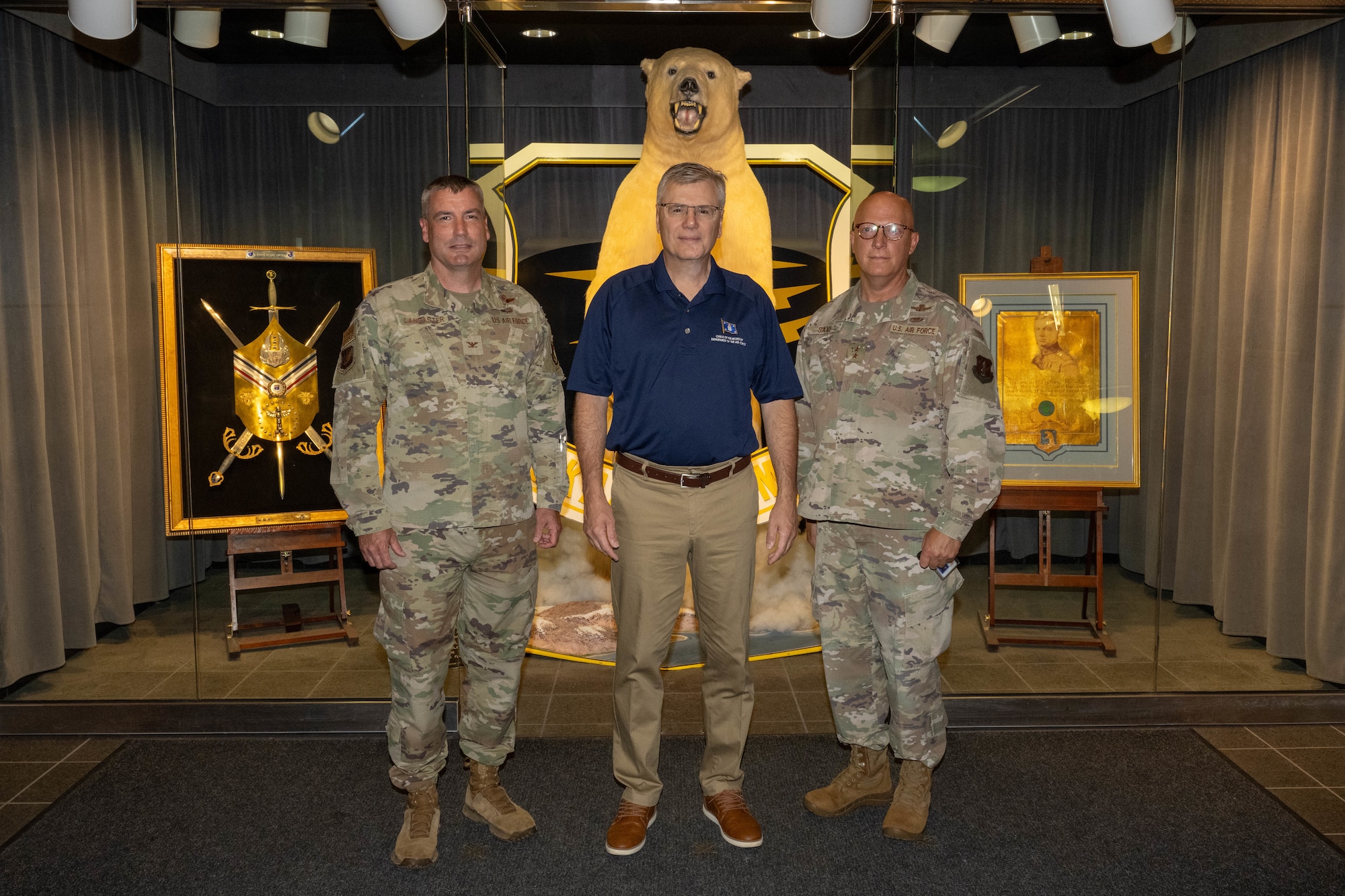 From left, U.S. Air Force Col. Philip Lancaster, 11th Air Force deputy commander, Secretary of the Air Force Troy Meink, and Maj. Gen. Torrance Saxe, Alaska National Guard Adjutant General, stand in front of the Alaskan Command display on Joint Base Elmendorf-Richardson, Alaska, July 31, 2025.