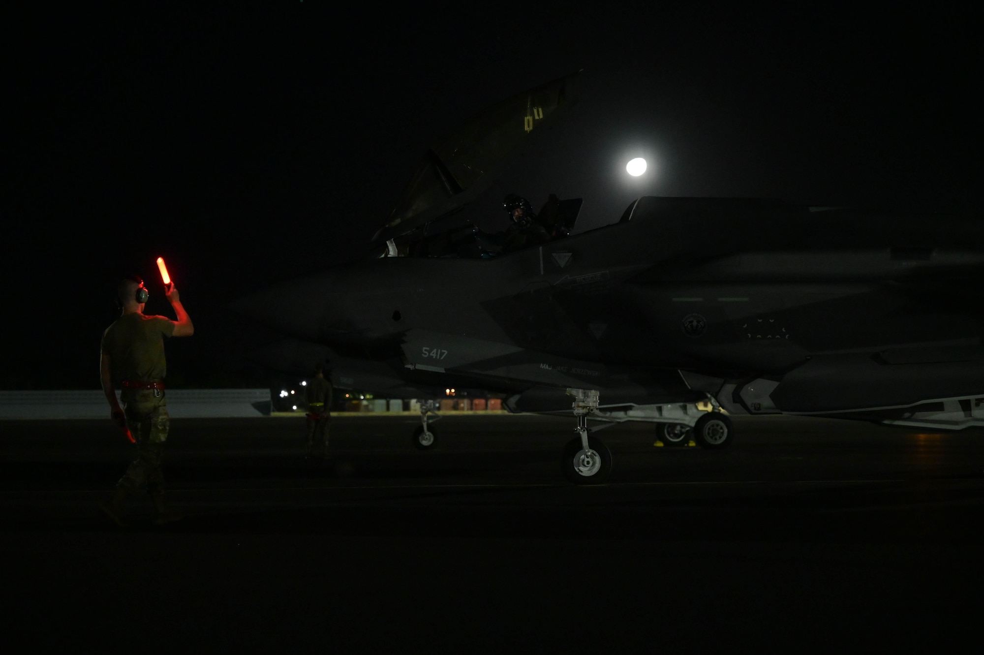 Airmen doing a precheck flight inspection on an aircraft.