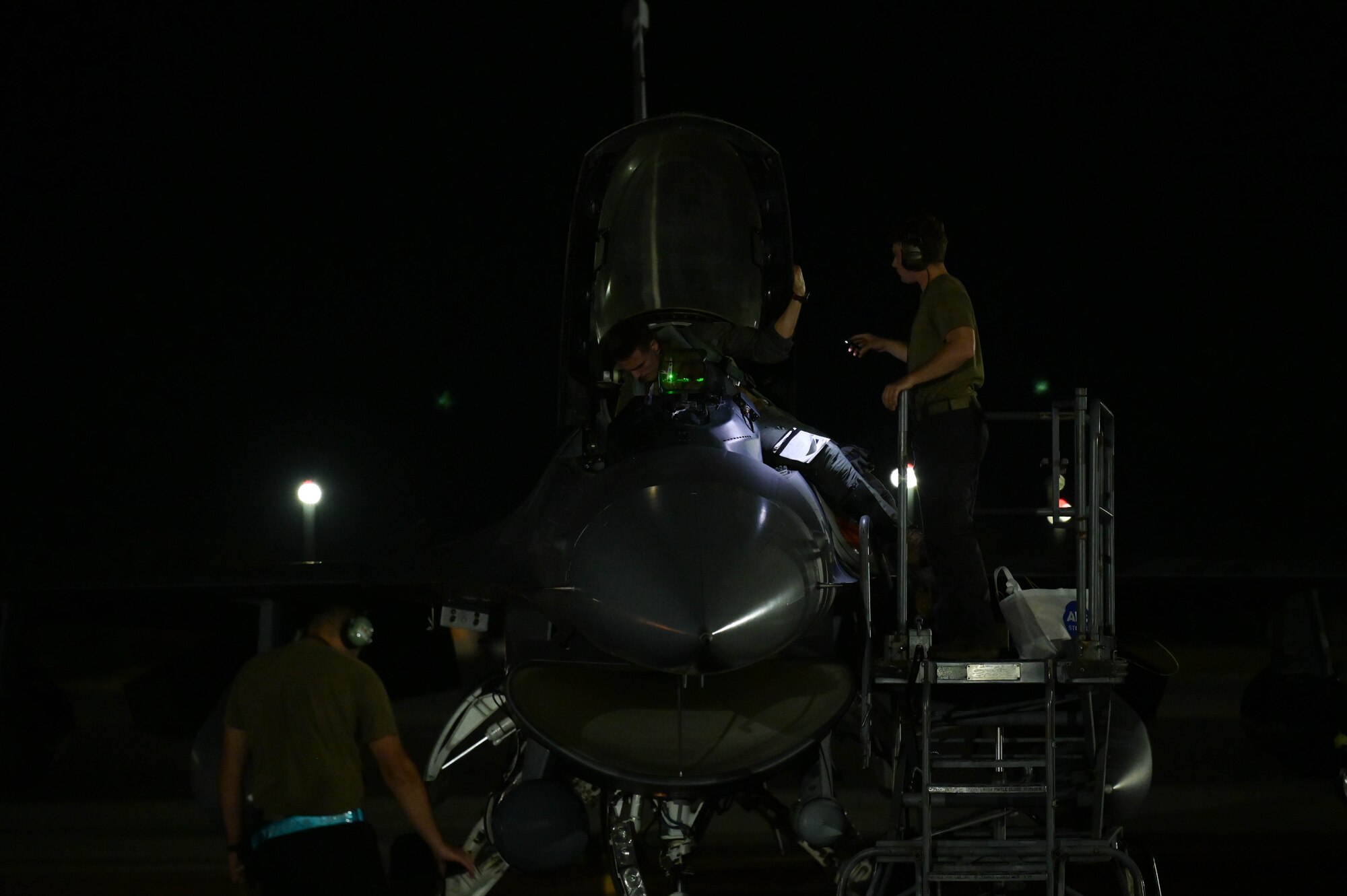 Maintenance performs a preflight check on an aircraft.