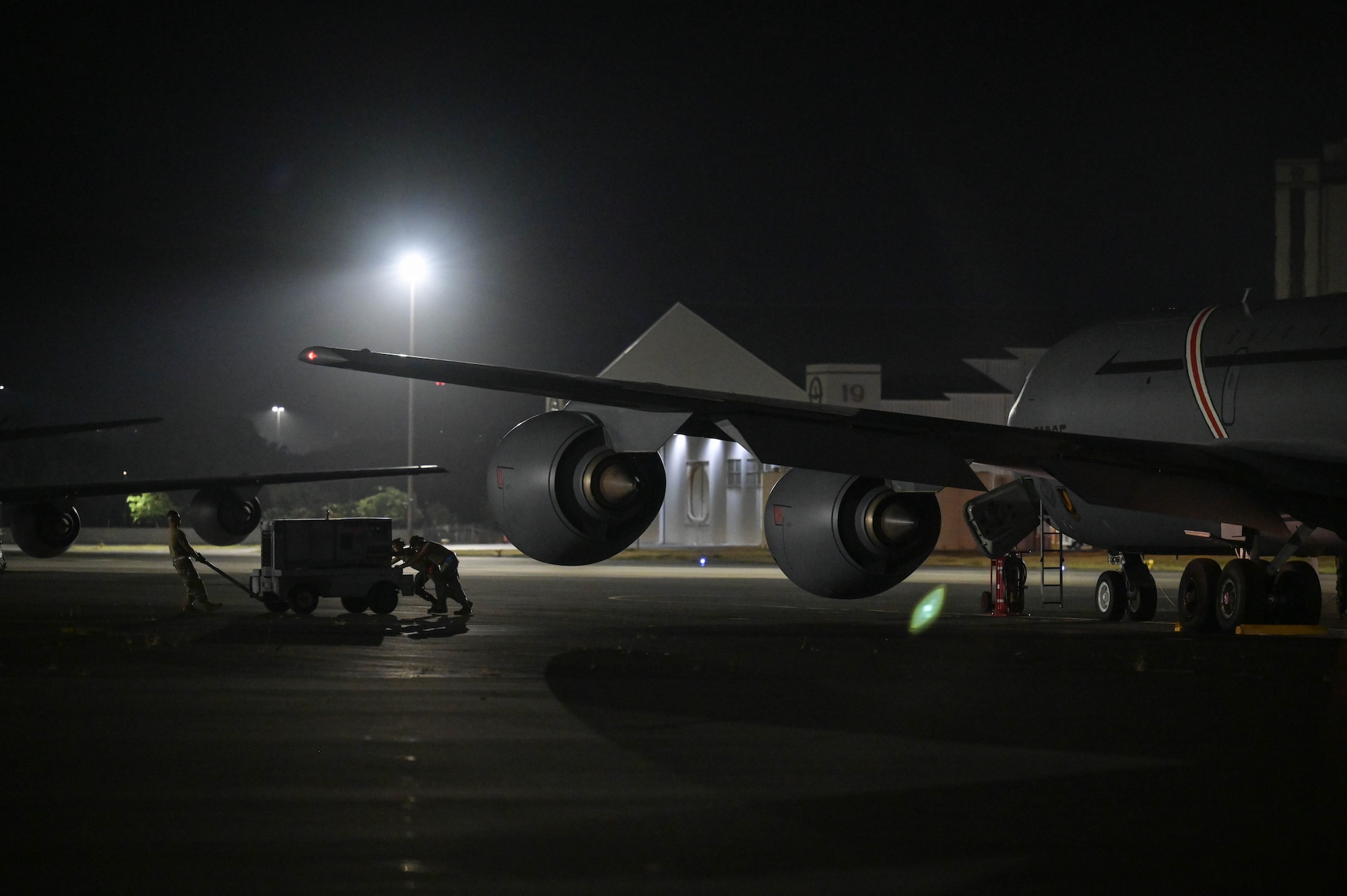 Maintenance pushing equipment away from an aircraft.