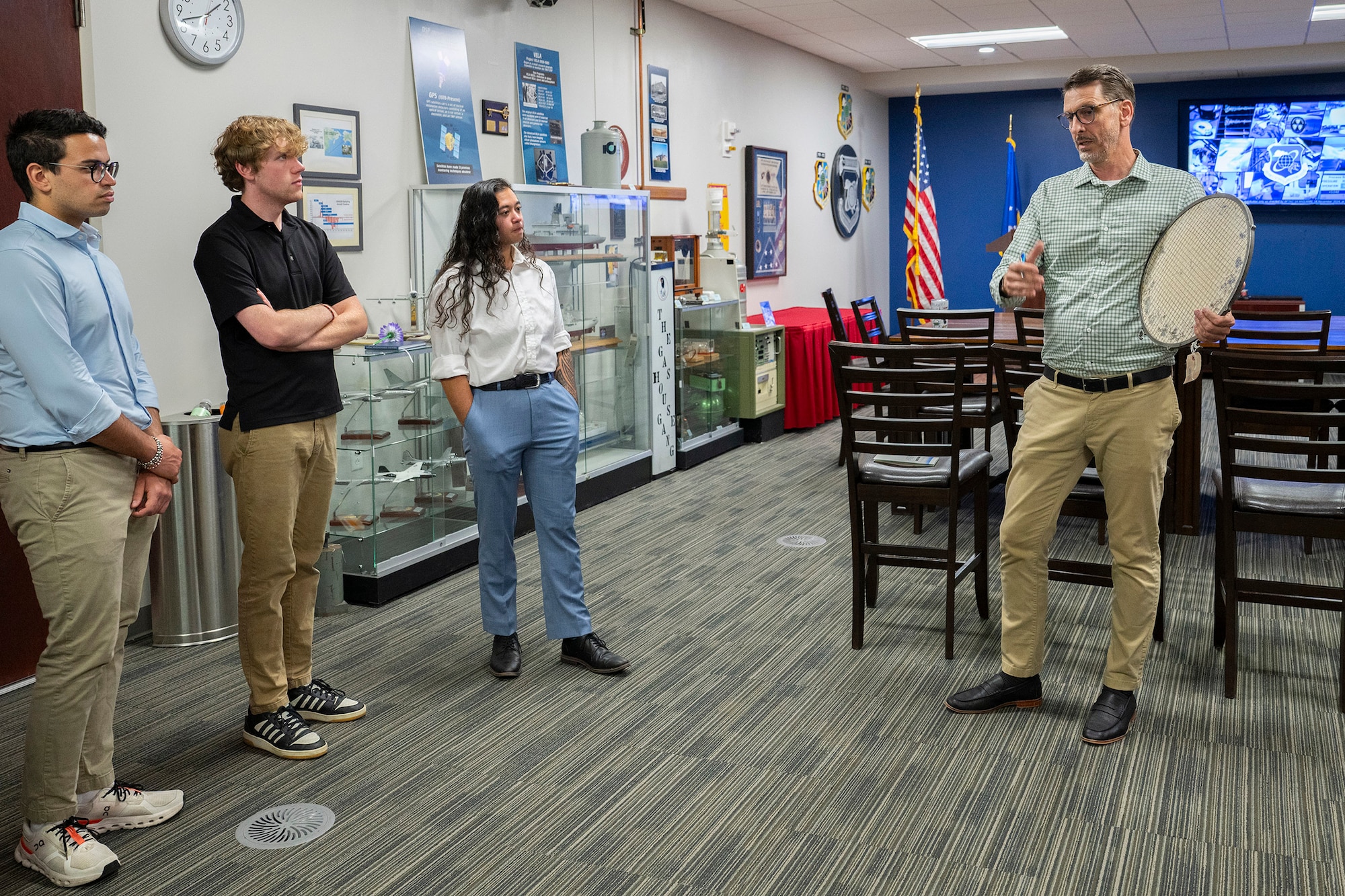 Dr. Matthew Loving (right), Historian for the Air Force Technical Applications Center at Patrick Space Force Base, Fla., talks about the mission of the Department of Defense’s sole nuclear treating monitoring organization to students participating in the U.S. Air Force’s SMART Scholar Program.  SMART, which stands for science and math research transformation, is a program that annually awards full-tuition, merit-based scholarships to hundreds of bachelor’s, master’s and doctoral candidates who are pursuing degrees in science, technology, engineering and math.   Pictured with Loving are Enrique Medici, Jackson Neering, and Lindsey Ukishima.  (U.S. Air Force photo by Matthew S. Jurgens)