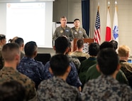 U.S. Air Force Brig. Gen. John Gallemore (Left), 18th Wing commander, and Captain Otto Yan 18th Operations Support Squadron OSK Flight commander, address the audience during the Bilateral Defense of Okinawa Working Group outbrief at Kadena Air Base, Japan, August 1, 2025