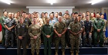U.S. Air Force, U.S. Marine Corps and Japan Air Self-Defense Force members pose for a photo during the Bilateral Defense of Okinawa Working Group outbrief at Kadena Air Base, Japan, August 1, 2025.