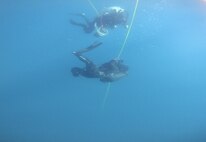Explosive Ordnance Disposal 1st Class Grant Shaffer and a member of the Japanese Maritime Self Defense Force Explosive Ordnance Disposal detachment conduct a dive on training shapes during Mine Warfare Exercise (MINEX) 2JA near Ominato, Japan, July 21, 2025.