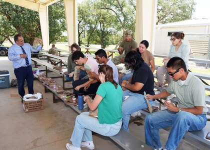 JOINT BASE SAN ANTONIO-FORT SAM HOUSTON – (July 23, 2025) – Student interns assigned to Naval Medical Research Unit (NAMRU) San Antonio enrolled in the Office of Naval Research’s Naval Research Enterprise Internship Program (NREIP) and Oak Ridge Institute for Science and Education (ORISE) had the opportunity to eat Meals, Ready-to-Eat for lunch during their trip to the Camp Bullis. Prior to lunch, the interns observed Air Force Expeditionary Medical Service (EMEDS) training at the camp. Navy Medicine Research & Development (NMR&D) makes use of multiple channels to recruit and retain critical U.S. Navy medical support personnel. The research commands reach out to the next generation of scientists through conferences, STEM events, internships and career days, and support recruiting efforts early in undergraduate and graduate programs. NAMRU San Antonio, part of NMR&D, conducts gap-driven combat casualty care, craniofacial, and directed energy research in support of Navy, Marine Corps and joint U.S. warfighter health readiness and lethality while engaged in routine and expeditionary operations. (U.S. Navy photo by Burrell Parmer, NAMRU San Antonio Public Affairs/Released)