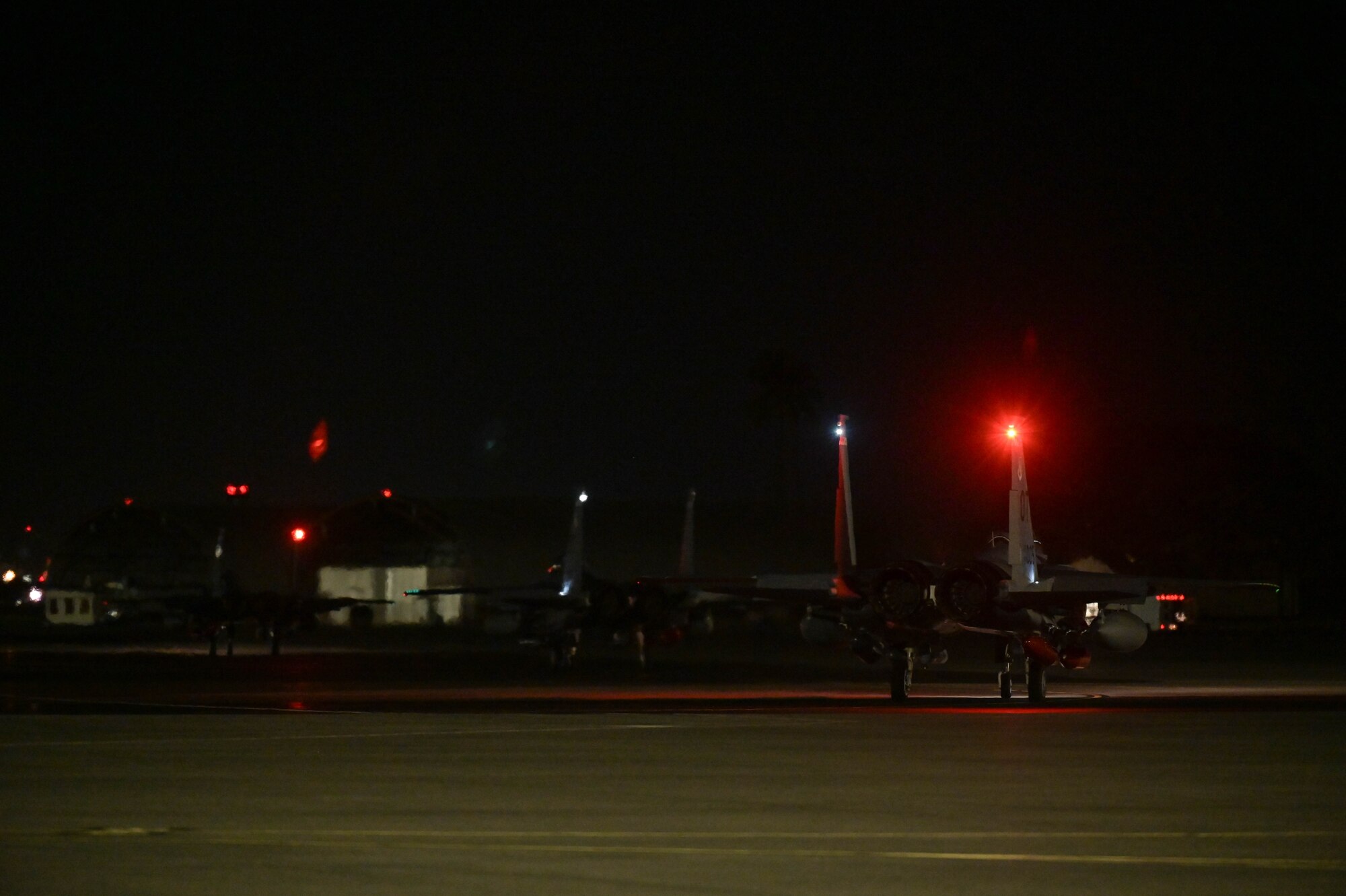 Three aircraft taxiing on the flight line.