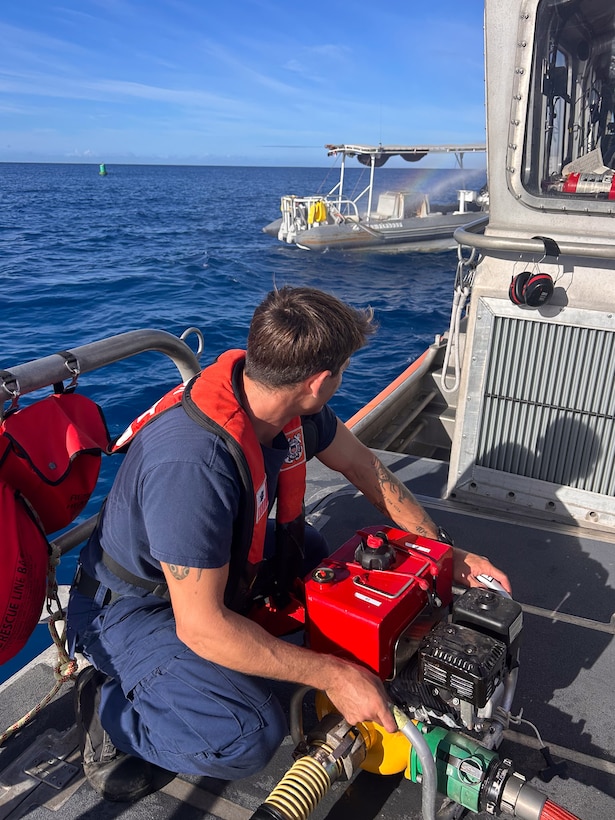 Petty Officer 2nd Class David Vollucci, a crew member assigned to Coast Guard Station Honolulu, operates a P-6 dewatering pump on the deck of a 45-foot Response Boat-Medium offshore Honolulu, Hawaii, Aug. 6, 2025. The Station Honolulu boat crew assisted the Honolulu Fire Department with extinguishing a fire on a 29-foot uninspected passenger vessel near Ala Wai Harbor. (U.S. Coast guard photo, courtesy Station Honolulu)