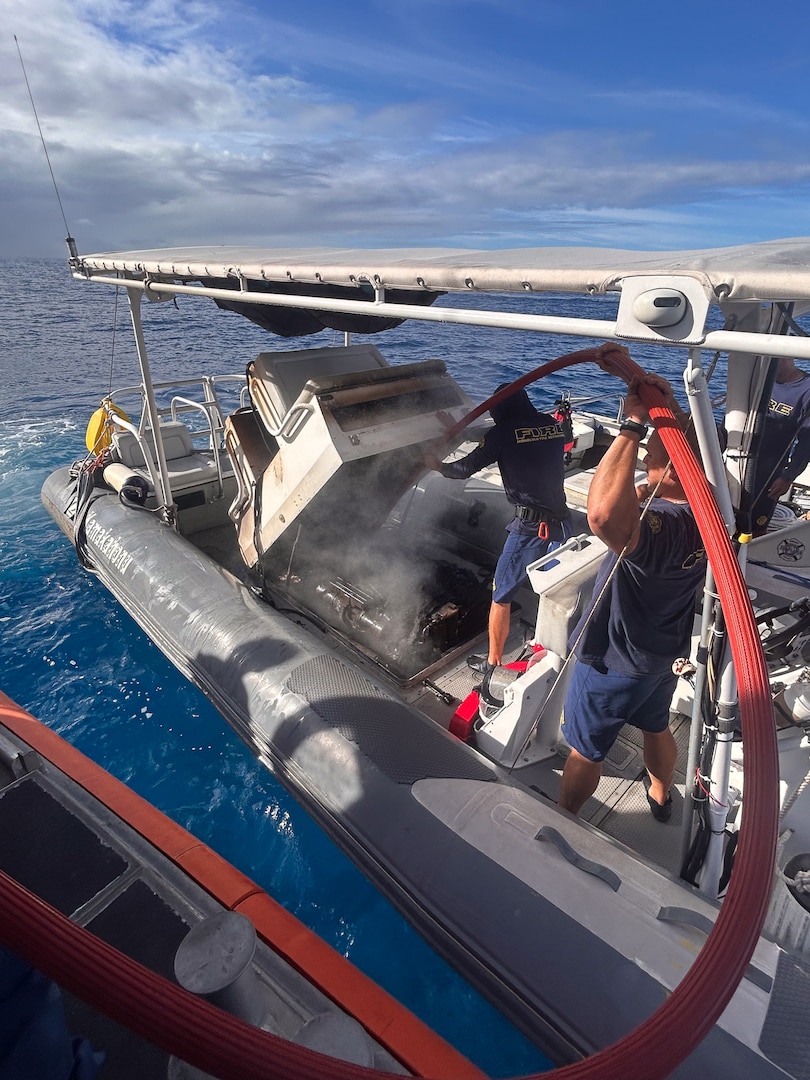 Members of the Honolulu Fire Department fight a boat fire using a P-6 dewatering pump from Coast Guard Station Honolulu's 45-foot Response Boat-Medium near Ala Wai Harbor in Honolulu, Hawaii, Aug. 6, 2025. Crew members from both the Honolulu Fire Department and Station Honolulu worked to extinguish the fire after good Samaritans evacuated six people from the burning boat. (U.S. Coast Guard photo, courtesy Station Honolulu)