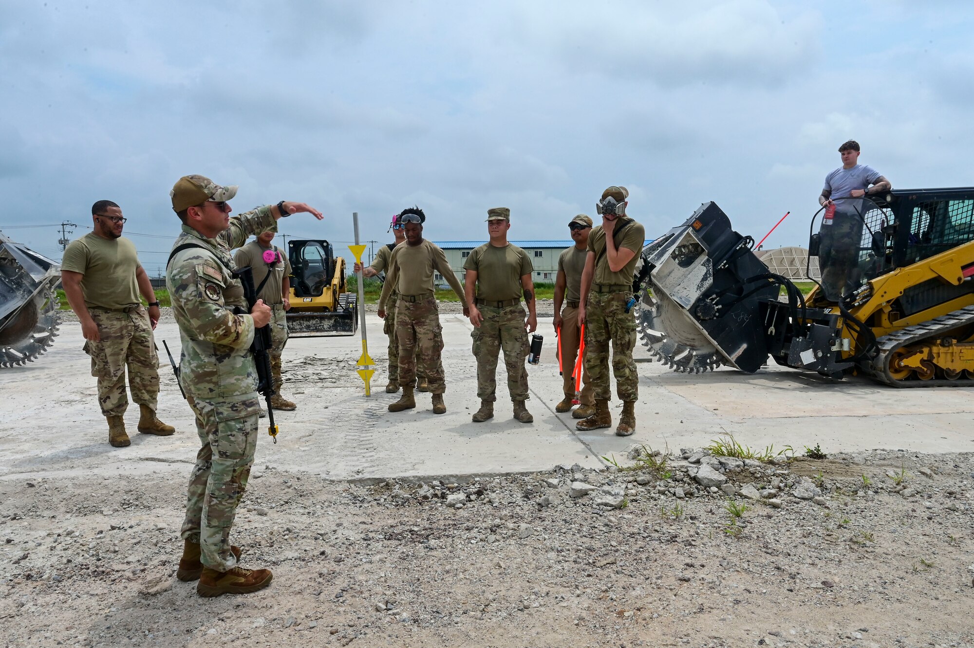 The 8th Civil Engineer Squadron Red Devils attend a safety brief prior to practicing Rapid Airfield Damage Repair (RA/DR) during exercise Beverly Sentinel 25-3 at Kunsan Air Base, Republic of Korea, Aug. 6, 2025. Beverley Sentinel is a combat readiness exercise that tests the Wolf Pack’s ability to survive and operate in a contested environment.