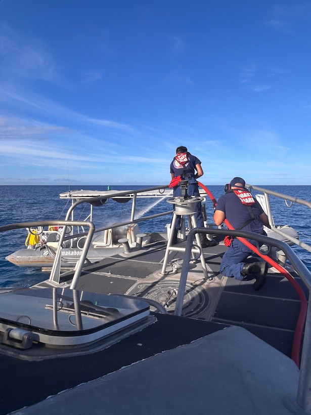 Crew members assigned to Coast Guard Station Honolulu fight a boat fire from the bow of a 45-foot Response Boat-Medium near Ala Wai Harbor in Honolulu, Hawaii, Aug. 6, 2025. The Coast Guard boat crew assisted a Honolulu Fire Department rescue boat crew with extinguishing the engine fire. (U.S. Coast Guard photo, courtesy Station Honolulu)