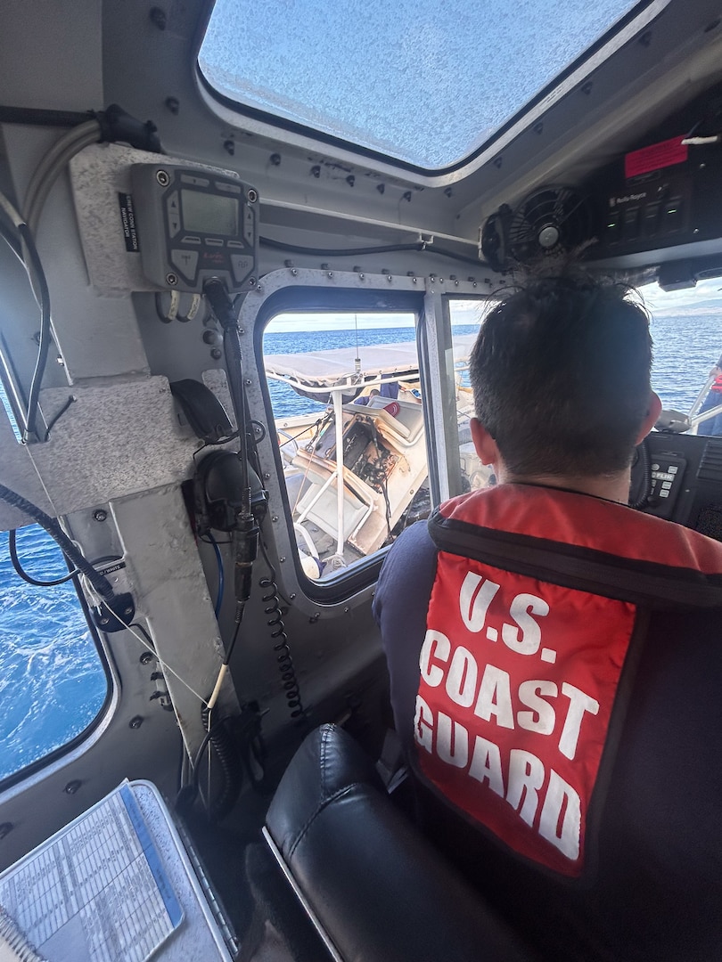 Petty Officer 3rd Class Ethan Chandler, a boatswain's mate assigned to Coast Guard Station Honolulu, operates a 45-foot Response Boat-Medium alongside a vessel that caught fire near Ala Wai Harbor in Honolulu, Hawaii, Aug. 6, 2025. The Station Honolulu crew responded to the boat fire alongside the Honolulu Fire Department, marking Chandler's first case as a coxswain. (U.S. Coast Guard photo, courtesy Station Honolulu)