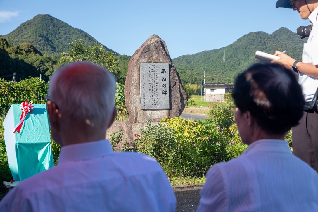 Shigeaki Mori, a Japanese historian and Hiroshima atomic bombing survivor, and his wife, Kayoko Mori, attend an unveiling ceremony in Yanai, Japan, July 28, 2025. Mr. Mori is a prominent historian, and his work was critical in documenting the fate of the Lonesome Lady and her crew. (U.S. Marine Corps photo by Lance Cpl. Micah Taylor)