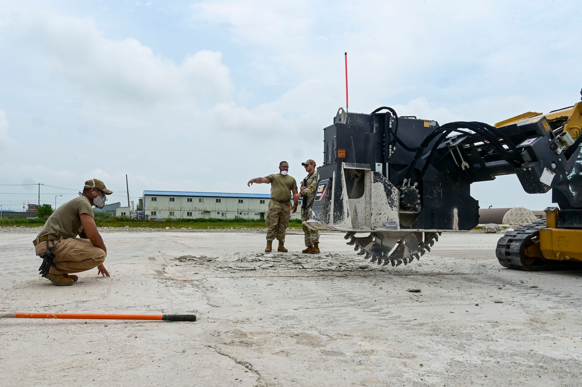 Airmen from the 8th Civil Engineer Squadron ensure a pavement saw is in the proper position during exercise Beverly Sentinel 25-3 at Kunsan Air Base, Republic of Korea, Aug. 6, 2025. The 8th CES practiced Rapid Airfield Damage Repair (RA/DR) to ensure they maintain the ability to quickly restore damaged airfields after attacks, enabling flight operations to continue.