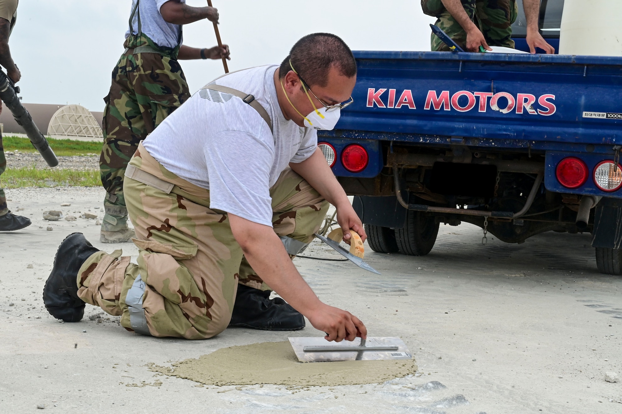 U.S. Air Force Staff Sgt. Luis Romano, 8th Civil Engineer Squadron heating, ventilation and air conditioning spall team member, smooths a concrete patch over a hole during exercise Beverly Sentinel 25-3 at Kunsan Air Base, Republic of Korea, Aug. 6, 2025. The hole was created on an area of the flightline where the Red Devils practice Rapid Airfield Damage Repair (RA/DR).