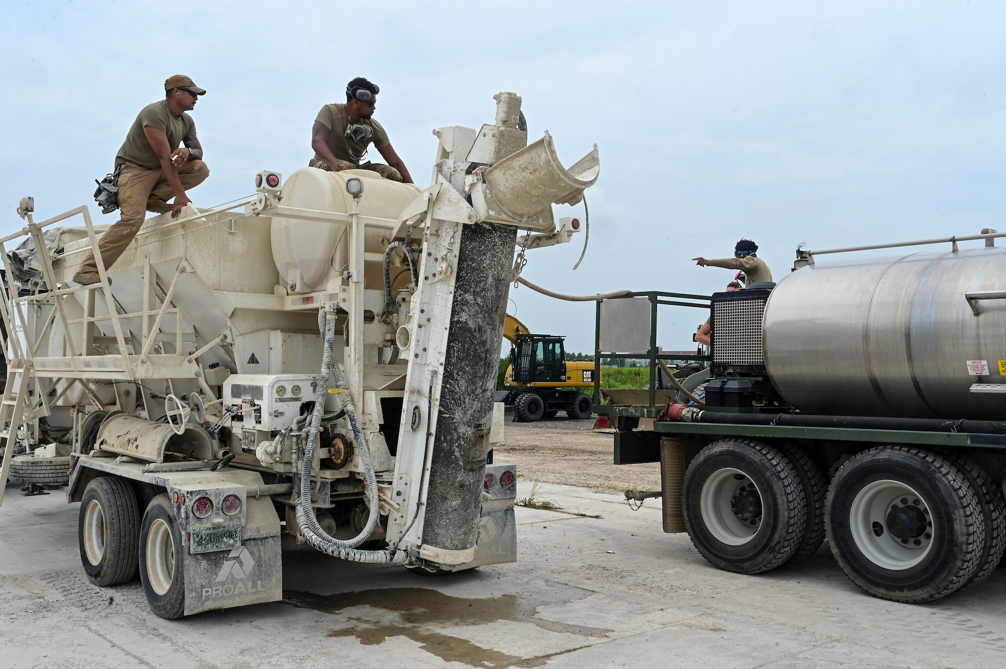 Airmen from the 8th Civil Engineer Squadron transfer water into a cement mixing truck during exercise Beverly Sentinel 25-3 at Kunsan Air Base, Republic of Korea, Aug. 6, 2025. The 8th CES practiced Rapid Airfield Damage Repair (RA/DR) to ensure they maintain the ability to quickly restore damaged airfields after attacks, enabling flight operations to continue.