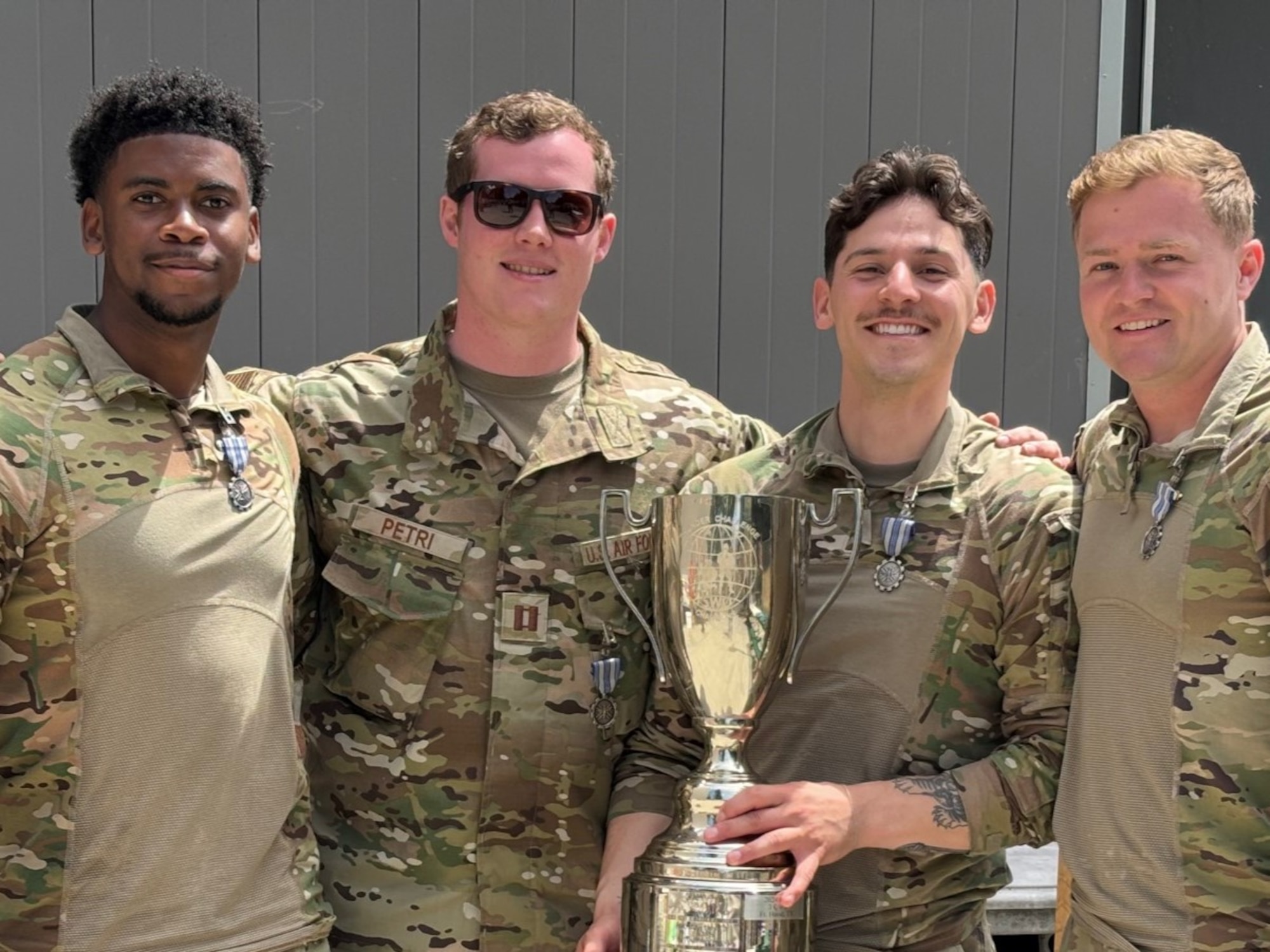 From left to right: Senior Airman Bobby Lewis, Capt. Griffin Petri, Staff Sgt. Fransico Estrada, Tech. Sgt. Joseph Miller pose with their trophy after winning Thunder Challenge 2025, an annual competition designed to test the tactical proficiencies and weather expertise of combat weather Airmen, July 8-10. (Courtesy Photo)