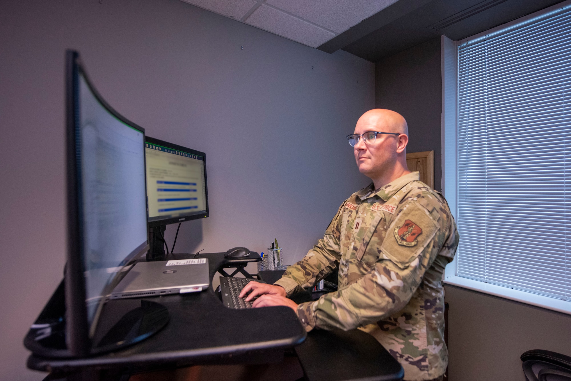 man stands at computer