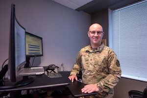 man poses at computer