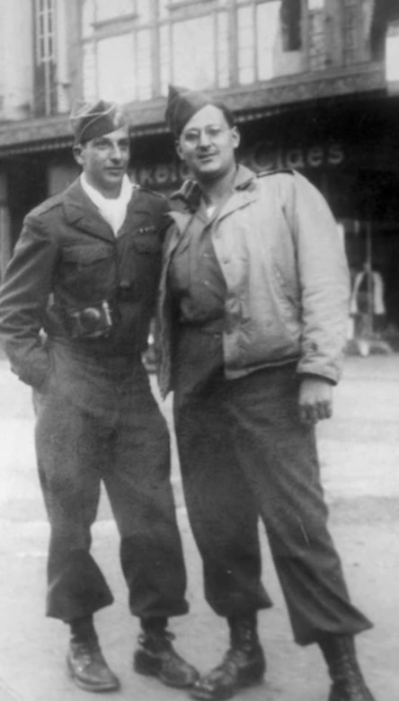 A black and white photo of two service members in uniform.