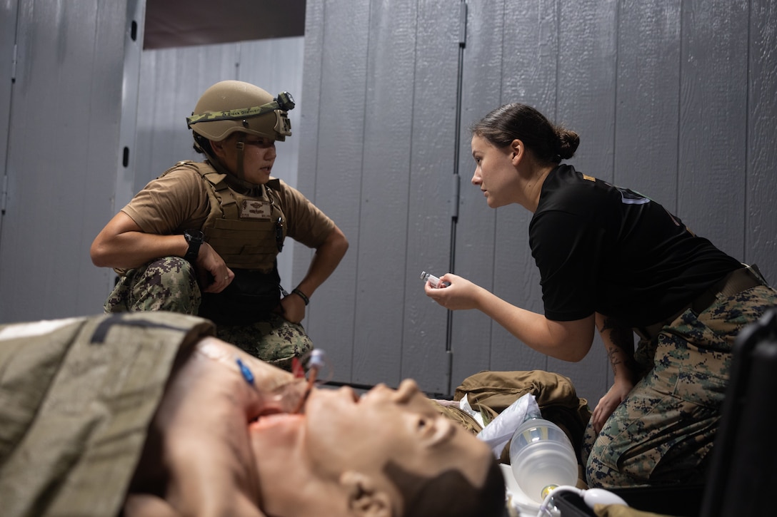 U.S. Navy Lt. Cmdr. Carolan Whitney, left, receives feedback from Lt. Allison Dilan, both

medical officers with 2nd Medical Battalion, 2nd Marine Logistics Group, instructs a student

during a Tier IV Tactical Combat Casualty Care Course at the Battle Skills Training School,

Marine Corps Base Camp Lejeune, North Carolina, July 21, 2025. This was the first ever Tier IV TCCC hosted by a Marine Corps command and the first course executed by U.S. Navy personnel on the East Coast. The course trains select military service members to become proficient combat paramedics capable of providing advanced casualty care at the point of injury on the battlefield and in austere environments.