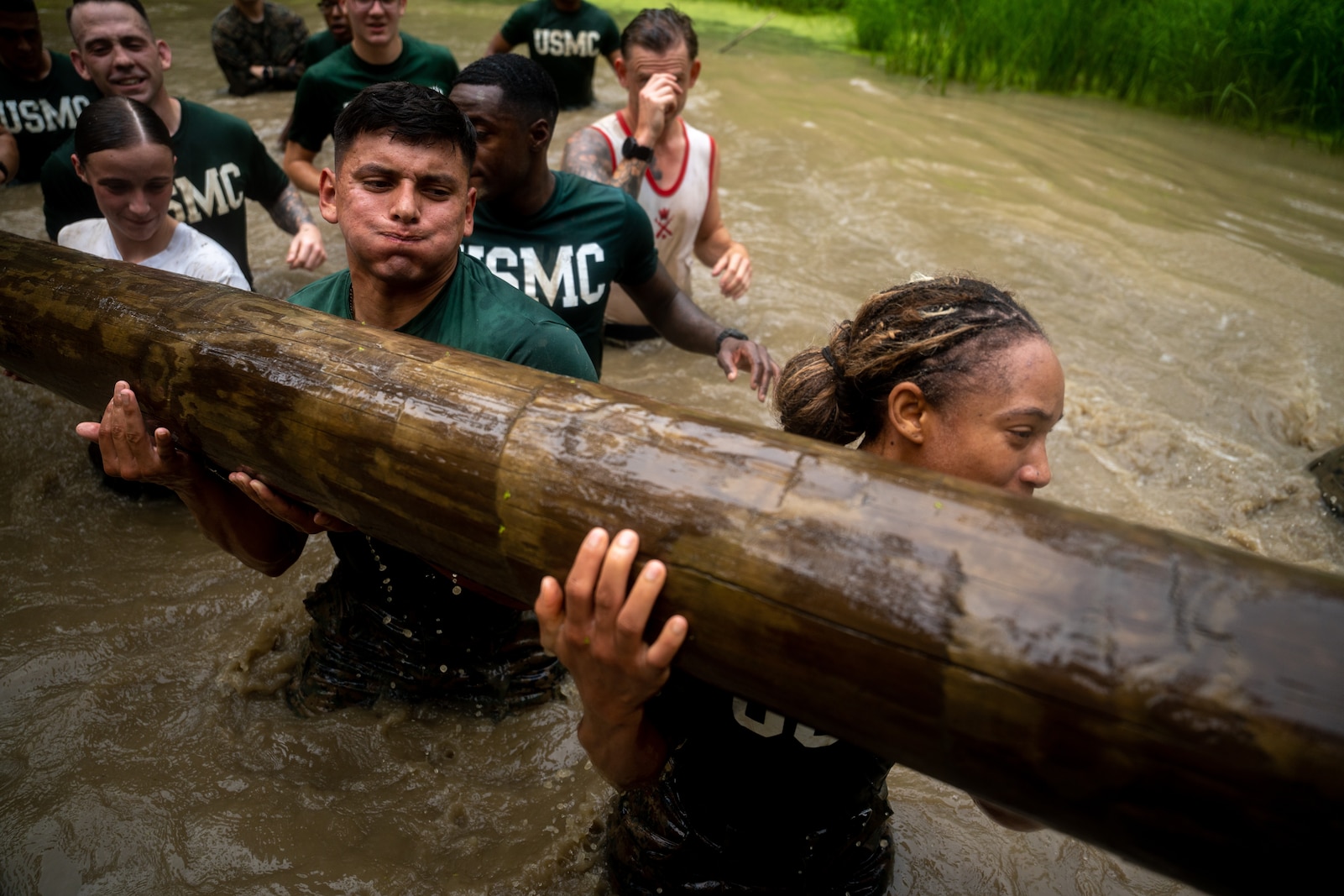U.S. Marine Corps Physical Training Instructors participate in a log carry while conducting the Montford Point Challenge at the Officer Candidate School on Marine Corps Base Quantico, Aug. 5, 2025. Candidates, Sergeant Instructors, and Physical Training Instructors complete the course in honor of the Montford Point Marines which were the first African Americans to enlist in the U.S. Marine Corps and instilling the corps warfighting mentality. (U.S. Marine Corps photo by Cpl. Joshua Munsen)