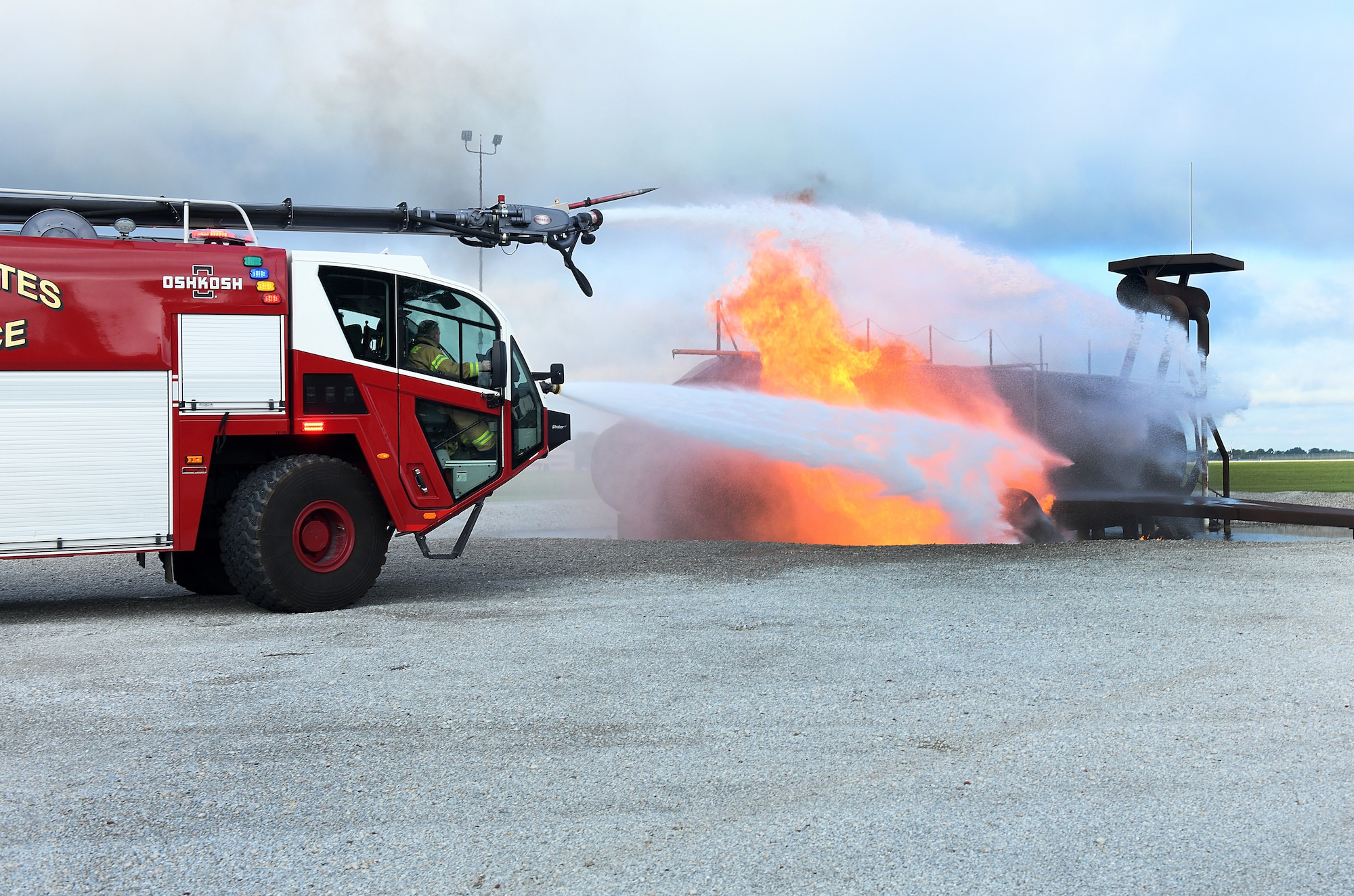 Offutt firefighters work on putting out a fire from a simulated crashed aircraft on the flightline during a Major Accident Response Exercise at Offutt Air Force Base, Nebraska, July 30, 2025. Emergency crews were evaluated on their response to the incident and if proper procedures and protocols were followed. (U.S. Air Force photo by Charles Haymond)