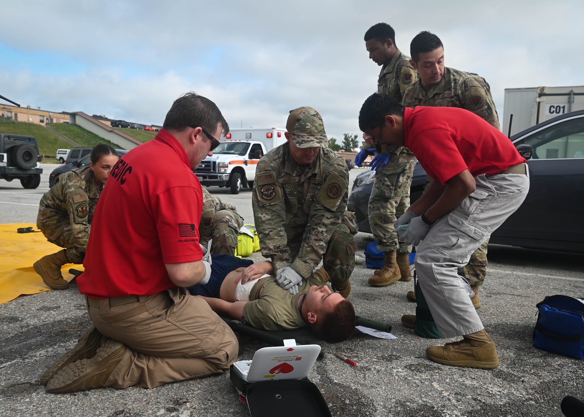 Airmen and civilian personnel from the 55th Medial Group provide treatment to a simulated injured Airman during a Major Accident Response Exercise on Offutt Air Force Base, Nebraska, July 30, 2025. After initial medical treatment was provided, emergency crews simulated the transport of the victims to the hospital. (U.S. Air Force photo by Daniel Martinez)