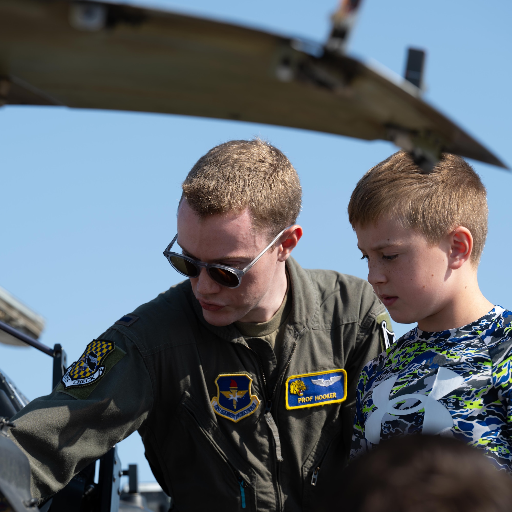 U.S. Air Force 1st Lt. Peyton Hooker, 85th FTS, instructor pilot, shows a participant of Tiger for a Day the cockpit of the T-6 Texan II at Laughlin Air Force Base, Texas, Aug. 5, 2025. Participants were able to see the aircraft that 85th FTS train their pilots in. (U.S. Air Force photo by Airman 1st Class Harrison Sullivan)